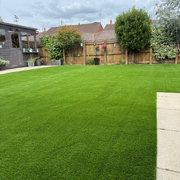 Artificial Lawn Cut In Against a Paved Edge Strip