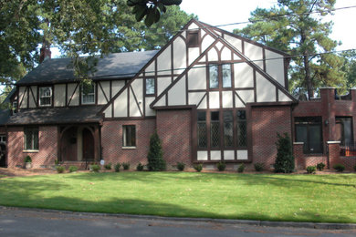 Example of a large classic red two-story concrete fiberboard gable roof design in Other