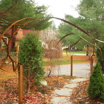 Hidden Patio with Steel-Ribboned Arbor