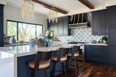Mid-sized transitional l-shaped dark wood floor, brown floor and exposed beam open concept kitchen photo in Denver with an undermount sink, recessed-panel cabinets, black cabinets, quartz countertops, blue backsplash, ceramic backsplash, stainless steel appliances, an island and white countertops