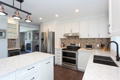 Inspiration for a mid-sized contemporary l-shaped dark wood floor and brown floor open concept kitchen remodel in Vancouver with an undermount sink, shaker cabinets, white cabinets, quartz countertops, multicolored backsplash, mosaic tile backsplash, stainless steel appliances, an island and multicolored countertops