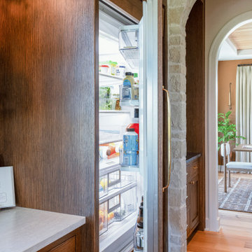 Panel-Ready Built-In Refrigerator & Stone Kitchen Archway
