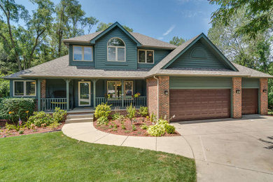 Craftsman green two-story mixed siding gable roof idea in Chicago