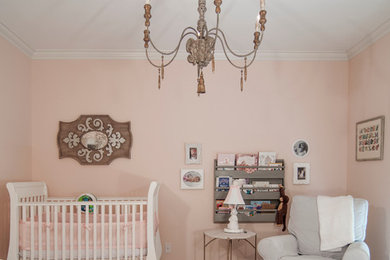 Mid-sized traditional nursery in Charlotte with pink walls and carpet for girls.