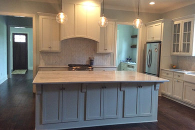 Kitchen - shabby-chic style kitchen idea in Birmingham with white cabinets, marble countertops, white backsplash, stainless steel appliances and an island