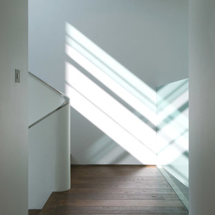 Small modern wood u-shaped metal railing staircase in London.