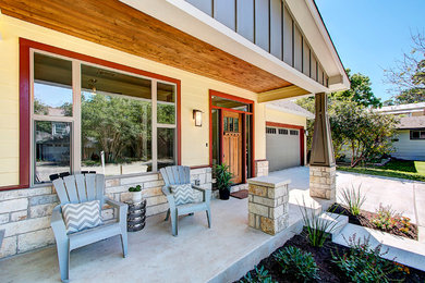 Mid-sized arts and crafts front yard verandah in Austin with concrete slab and a roof extension.
