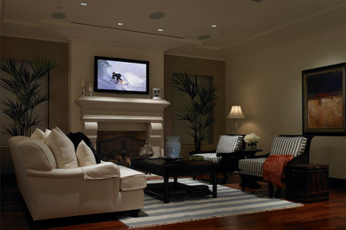 Inspiration for a large contemporary enclosed dark wood floor family room remodel in Los Angeles with white walls, a standard fireplace, a stone fireplace and a wall-mounted tv