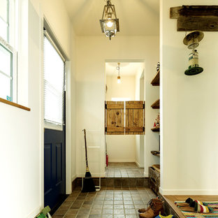 他の地域の中サイズの片開きドアビーチスタイルのおしゃれな玄関ホール (白い壁、テラコッタタイルの床、青いドア、ベージュの床) の写真