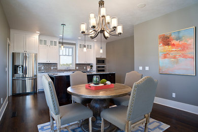 Example of a large arts and crafts kitchen design in Other with a farmhouse sink, shaker cabinets, granite countertops, glass tile backsplash, stainless steel appliances and an island