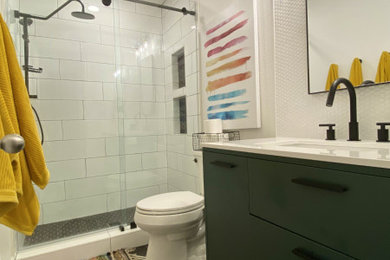 Example of a mid-sized trendy kids' white tile black floor and single-sink bathroom design in Austin with green cabinets, a two-piece toilet, an undermount sink, quartz countertops, white countertops and a freestanding vanity