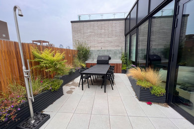 This is an example of a mid-sized modern concrete paver landscaping in New York.