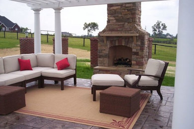 Example of a mid-sized transitional backyard patio design in Other with a fire pit and a pergola