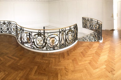 Hallway - large traditional medium tone wood floor and brown floor hallway idea in New York with white walls