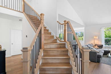 Large trendy wooden wood railing staircase photo in Portland with wooden risers