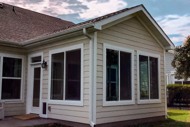 Inspiration for a timeless beige one-story exterior home remodel in Other with a shingle roof and a brown roof