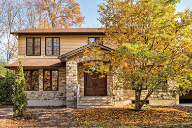 Mid-sized elegant beige two-story mixed siding house exterior photo in Burlington