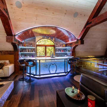 Glass private bar and glass stair treads inside a man cave in Michigan