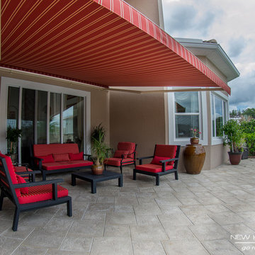 Retractable Screens and Awning give shade to gorgeous Windermere, FL home