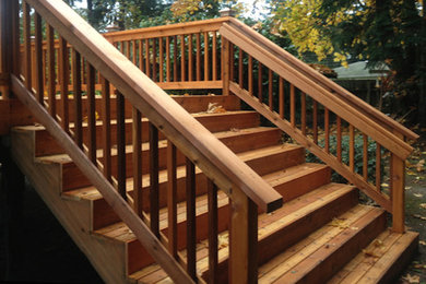 Example of a mid-sized wooden straight staircase design in Seattle with wooden risers