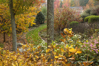 Inspiration for a large transitional partial sun side yard formal garden in Other.