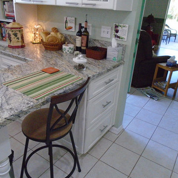 White painted kitchen cabinets with bevel edge laminate countertops
