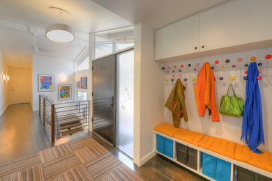 Example of a 1950s dark wood floor entryway design in Austin with white walls and a dark wood front door