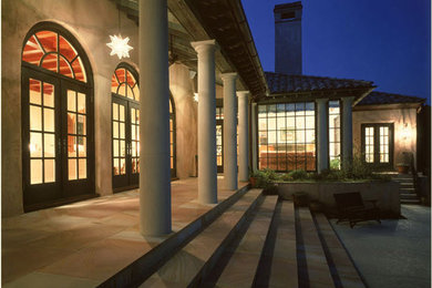 Huge tuscan beige two-story stucco exterior home photo in Charlotte with a hip roof