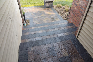 Inspiration for a concrete paver front porch remodel in Omaha
