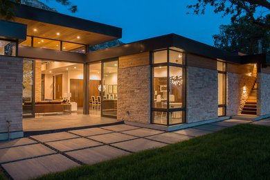 Inspiration for a mid-sized modern one-storey beige exterior in Salt Lake City with stone veneer.