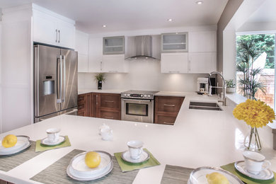 Large minimalist u-shaped ceramic tile eat-in kitchen photo in Montreal with an undermount sink, flat-panel cabinets, yellow cabinets, quartzite countertops, white backsplash, stone slab backsplash, stainless steel appliances and an island