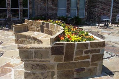 Patio - backyard stone patio idea in Dallas with no cover