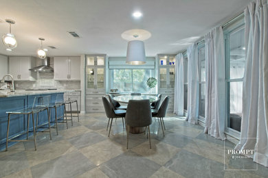 Mid-sized minimalist porcelain tile and multicolored floor kitchen/dining room combo photo in Austin with gray walls
