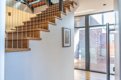 Photo of a mid-sized modern wood staircase in Perth with metal risers and metal railing.