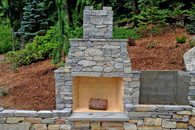 Inspiration for a rustic backyard landscaping in Seattle with a fire pit.
