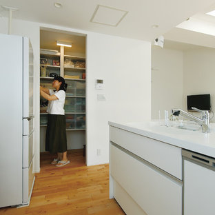 Mid-sized modern kitchen pantry inspiration - Example of a mid-sized minimalist single-wall light wood floor and beige floor kitchen pantry design in Yokohama with an undermount sink, open cabinets, white cabinets, solid surface countertops, white backsplash, white appliances, a peninsula and white countertops