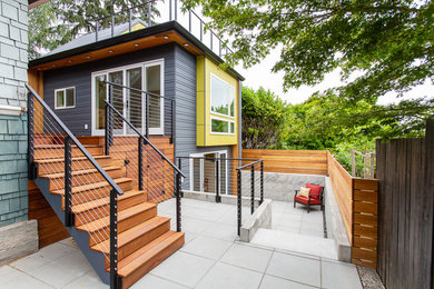Inspiration for a modern two-storey exterior in Seattle with concrete fiberboard siding and a metal roof.