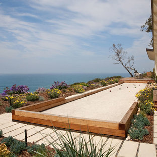 Photo of a mid-sized beach style backyard full sun outdoor sport court in Santa Barbara with concrete pavers.