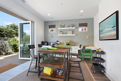 Example of a transitional built-in desk dark wood floor home office design in Orange County with gray walls