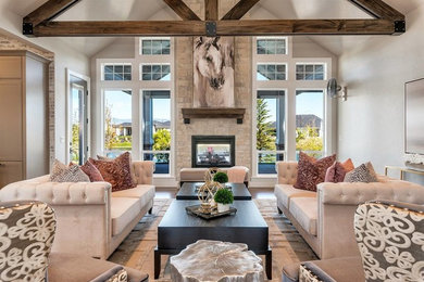 Living room - large transitional open concept medium tone wood floor and brown floor living room idea in Boise with beige walls, a two-sided fireplace, a stone fireplace and no tv