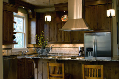 Open concept kitchen - mid-sized craftsman l-shaped open concept kitchen idea in Other with a single-bowl sink, raised-panel cabinets, dark wood cabinets, multicolored backsplash, stainless steel appliances and an island
