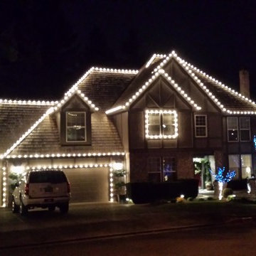 2 Story cedar shake with hip roof and peaks in white, and a splash of color in t