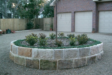 Natural sandstone garden driveway roundabout with formal plant such as mondo gra