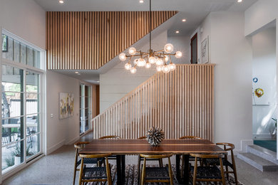 Example of a small mid-century modern gray floor great room design in Dallas with white walls and no fireplace