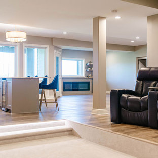 Inspiration for a medium sized traditional walk-out basement in Omaha with beige walls, light hardwood flooring, a ribbon fireplace, a plastered fireplace surround and beige floors.