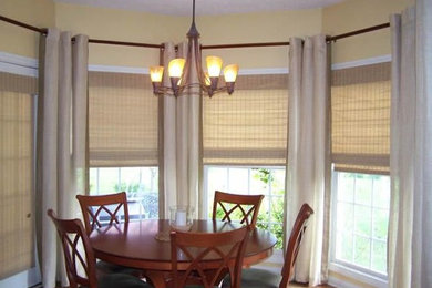 This is an example of a mid-sized transitional separate dining room in Cleveland with white walls, dark hardwood floors and brown floor.