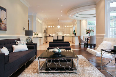Inspiration for a mid-sized transitional formal and open concept dark wood floor and brown floor living room remodel in Toronto with yellow walls, a standard fireplace, a wood fireplace surround and no tv