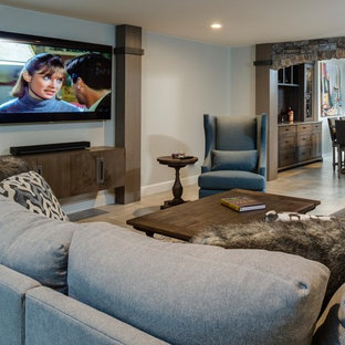 This is an example of a large industrial walk-out basement in Detroit with beige walls, porcelain flooring, a brick fireplace surround and beige floors.