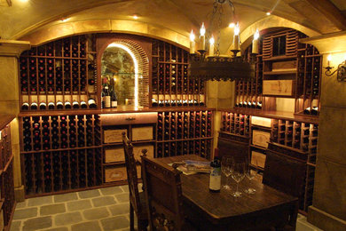 Mid-sized traditional wine cellar in Sacramento with ceramic floors, storage racks and grey floor.