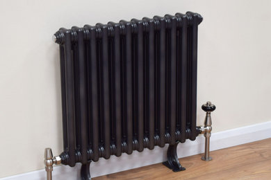 Infinity column radiator in black metallic finish with cast iron feet